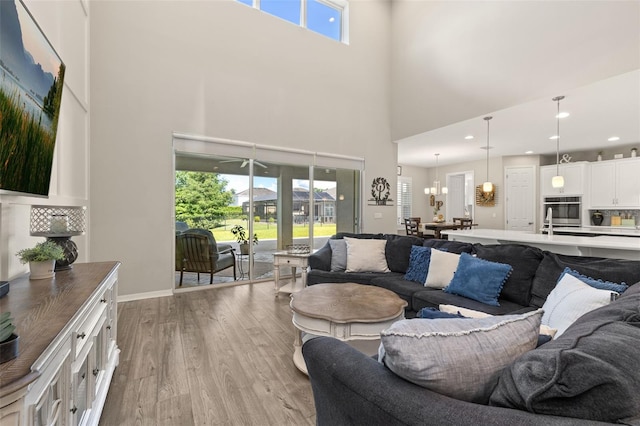 1113 Fieldstone Cir, Oviedo, FL 32765 - living area with light wood-type flooring and a towering ceiling