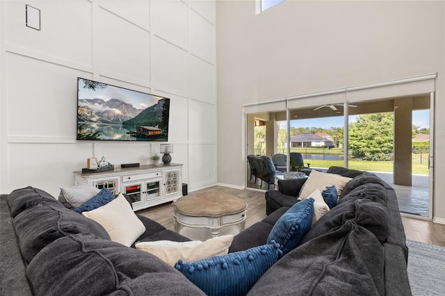 1113 Fieldstone Cir, Oviedo, FL 32765 - living area with healthy amount of natural light, a towering ceiling, and wood finished floors
