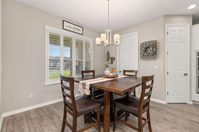 1113 Fieldstone Cir, Oviedo, FL 32765 - dining area with a chandelier and light wood-type flooring