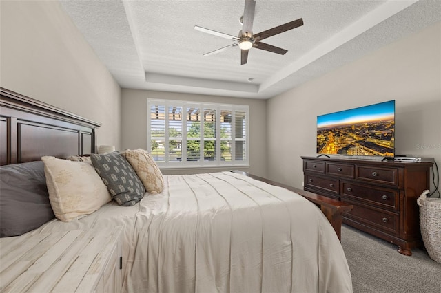 1113 Fieldstone Cir, Oviedo, FL 32765 - bedroom with carpet flooring, a textured ceiling, a tray ceiling, and ceiling fan
