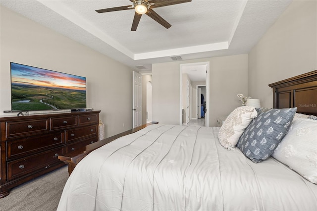 1113 Fieldstone Cir, Oviedo, FL 32765 - bedroom featuring a tray ceiling, light carpet, and a ceiling fan