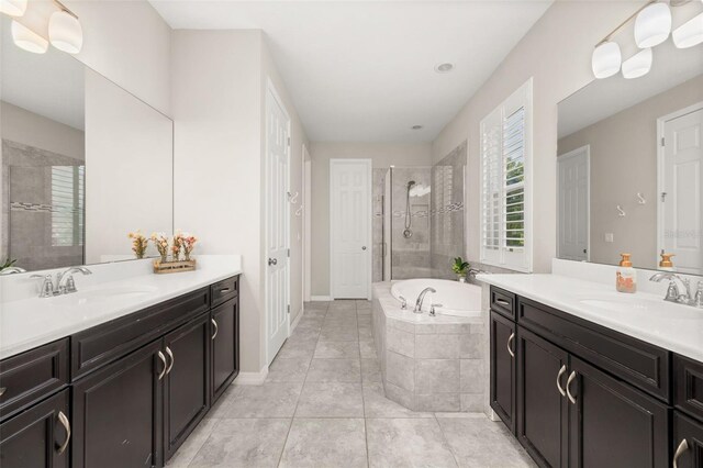 1113 Fieldstone Cir, Oviedo, FL 32765 - bathroom with two vanities, a garden tub, tiled shower, and tile patterned flooring