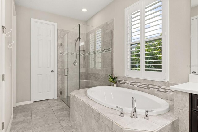 1113 Fieldstone Cir, Oviedo, FL 32765 - bathroom with a bath, a shower stall, vanity, tile patterned floors, and recessed lighting
