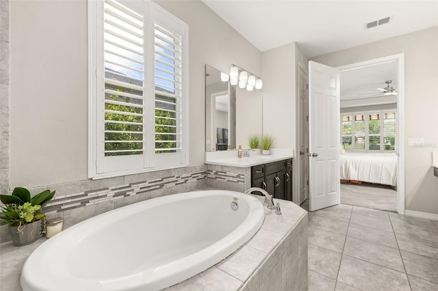 1113 Fieldstone Cir, Oviedo, FL 32765 - ensuite bathroom with vanity, a garden tub, tile patterned floors, and ceiling fan