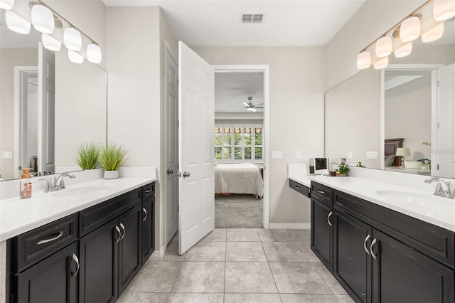 1113 Fieldstone Cir, Oviedo, FL 32765 - ensuite bathroom featuring two vanities, a ceiling fan, and tile patterned flooring
