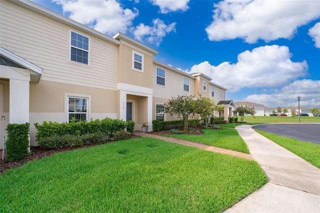 110 Claire Ln, Davenport, FL 33837 - multi unit property featuring stucco siding, a front yard, and a residential view