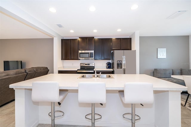 110 Claire Ln, Davenport, FL 33837 - kitchen featuring refrigerator with ice dispenser, stainless steel microwave, open floor plan, electric range, and a sink