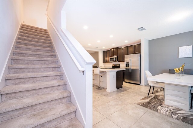 110 Claire Ln, Davenport, FL 33837 - staircase featuring tile patterned floors, baseboards, and recessed lighting