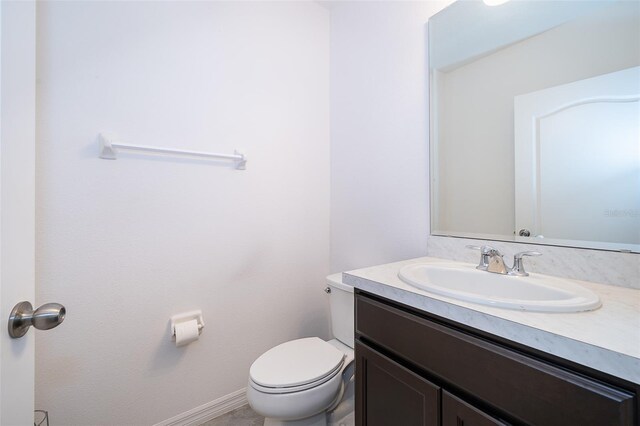 110 Claire Ln, Davenport, FL 33837 - bathroom with vanity, toilet, and baseboards