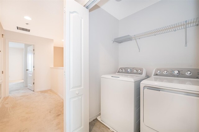 110 Claire Ln, Davenport, FL 33837 - washroom with washer and clothes dryer and light carpet