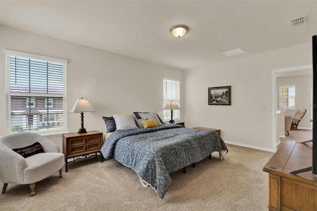 bedroom featuring light colored carpet and baseboards