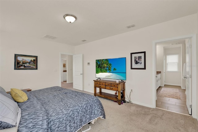 bedroom with baseboards and light carpet