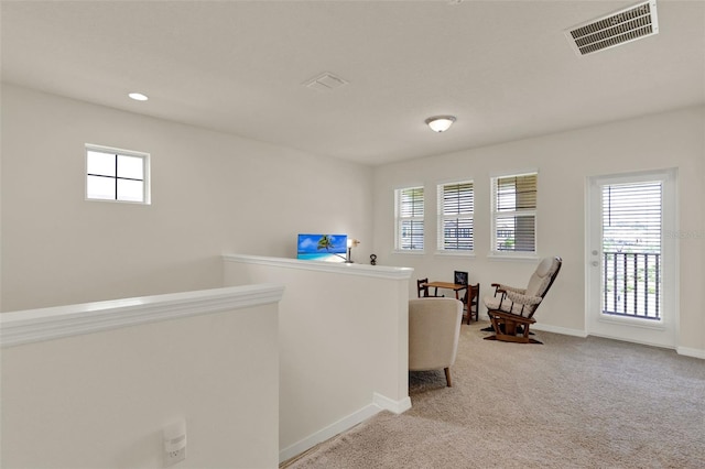 sitting room with light carpet, baseboards, an upstairs landing, and recessed lighting