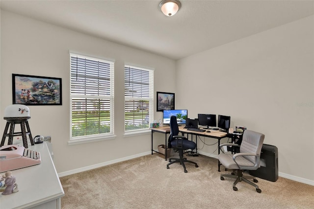carpeted office featuring baseboards