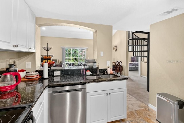 1321 Arbor Vista Loop Unit 301, Lake Mary, FL 32746 - kitchen with stainless steel dishwasher, white cabinets, dark stone countertops, and arched walkways