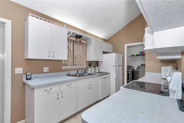 40533 E 8th Ave, Umatilla, FL 32784 - kitchen featuring washer and dryer, white appliances, light countertops, vaulted ceiling, and white cabinets