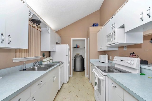 40533 E 8th Ave, Umatilla, FL 32784 - kitchen with white appliances, vaulted ceiling, light countertops, white cabinetry, and light floors