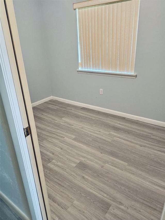 40533 E 8th Ave, Umatilla, FL 32784 - empty room featuring wood finished floors and baseboards