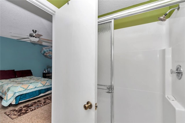 40533 E 8th Ave, Umatilla, FL 32784 - ensuite bathroom with a shower with shower door, a textured ceiling, and a ceiling fan