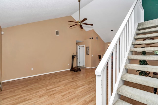 40533 E 8th Ave, Umatilla, FL 32784 - stairway with ceiling fan, high vaulted ceiling, and wood finished floors