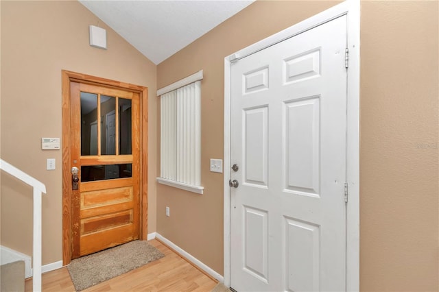 40533 E 8th Ave, Umatilla, FL 32784 - entrance foyer featuring lofted ceiling, light wood-style floors, and stairway