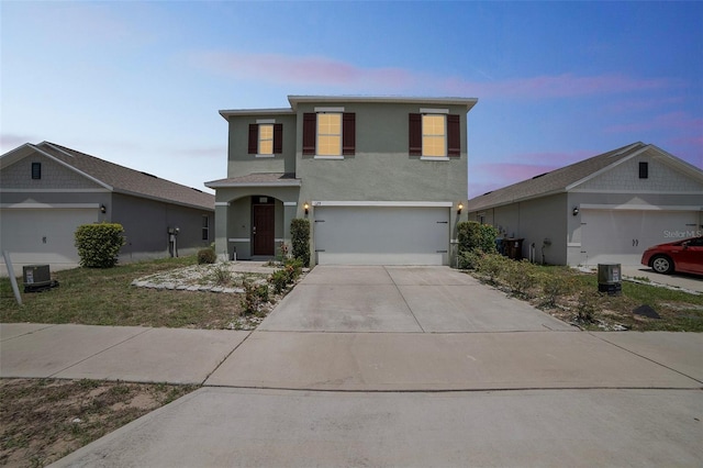 129 Eagleview Loop, Davenport, FL 33837 - traditional home featuring driveway, stucco siding, and an attached garage