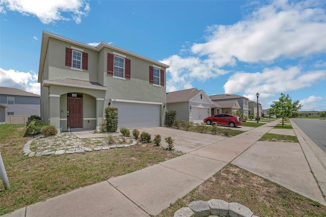 129 Eagleview Loop, Davenport, FL 33837 - traditional-style house featuring a garage, a residential view, driveway, and stucco siding