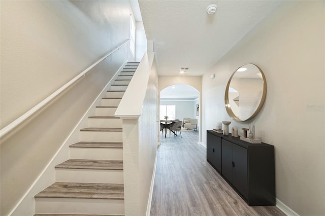 129 Eagleview Loop, Davenport, FL 33837 - stairway featuring arched walkways and wood finished floors