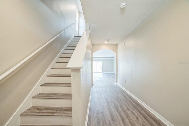 129 Eagleview Loop, Davenport, FL 33837 - stairway with arched walkways and wood finished floors