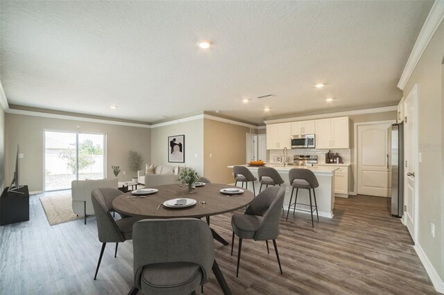 129 Eagleview Loop, Davenport, FL 33837 - dining space with dark wood-type flooring, crown molding, and recessed lighting