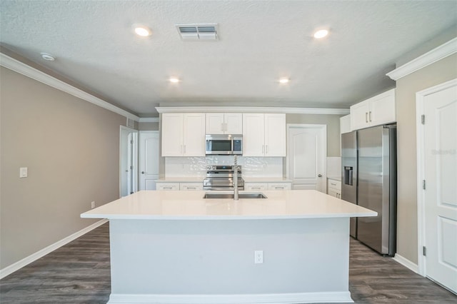 129 Eagleview Loop, Davenport, FL 33837 - kitchen with stainless steel appliances, ornamental molding, dark wood-style floors, tasteful backsplash, and an island with sink