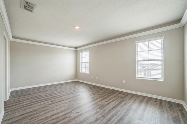 129 Eagleview Loop, Davenport, FL 33837 - empty room with dark wood finished floors, a textured ceiling, and ornamental molding