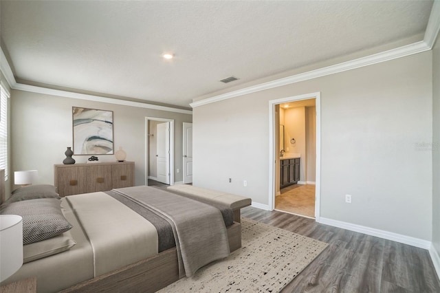 129 Eagleview Loop, Davenport, FL 33837 - bedroom featuring ornamental molding, dark wood-style flooring, and ensuite bath