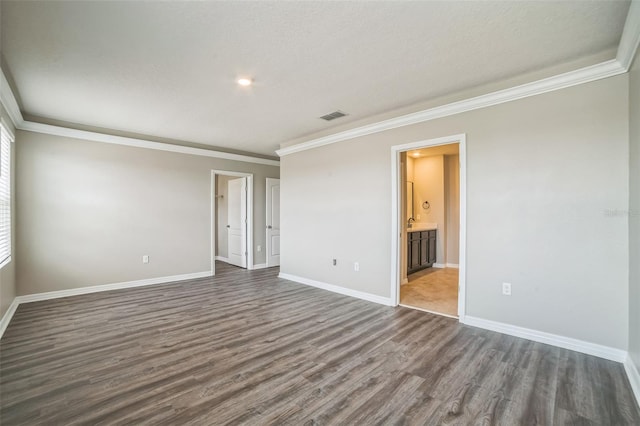 129 Eagleview Loop, Davenport, FL 33837 - empty room featuring ornamental molding and dark wood-type flooring