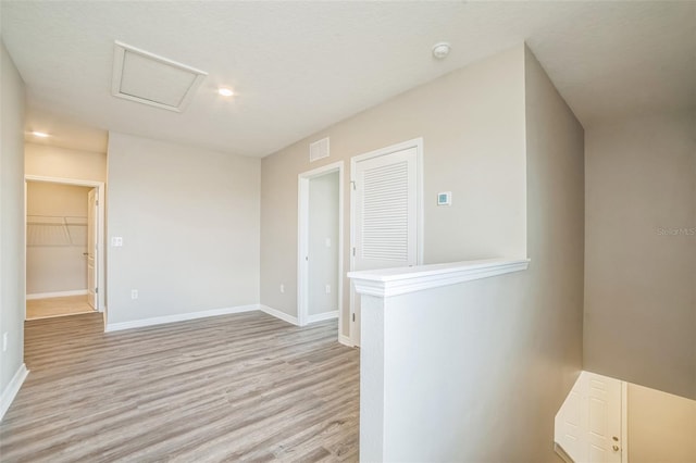 129 Eagleview Loop, Davenport, FL 33837 - spare room featuring light wood-style flooring, attic access, and a smoke detector