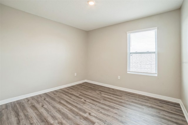 129 Eagleview Loop, Davenport, FL 33837 - unfurnished room with baseboards and wood finished floors