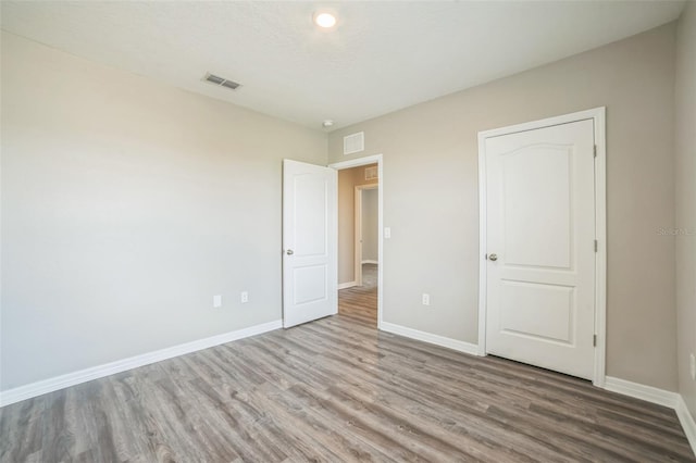 129 Eagleview Loop, Davenport, FL 33837 - unfurnished bedroom with wood finished floors and baseboards