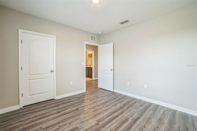 129 Eagleview Loop, Davenport, FL 33837 - unfurnished bedroom featuring wood finished floors and baseboards