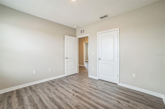 129 Eagleview Loop, Davenport, FL 33837 - unfurnished bedroom with wood finished floors