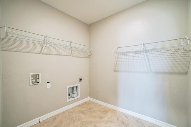 129 Eagleview Loop, Davenport, FL 33837 - laundry area featuring hookup for an electric dryer, washer hookup, and light tile patterned floors