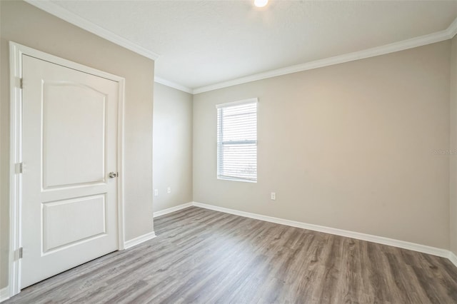 129 Eagleview Loop, Davenport, FL 33837 - unfurnished room with wood finished floors and crown molding