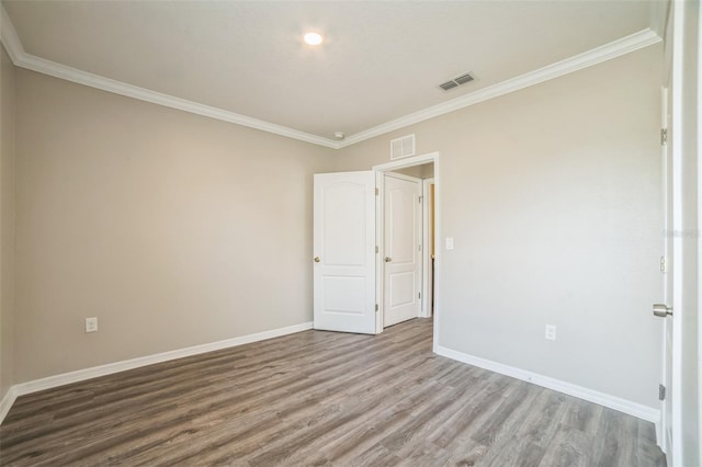 129 Eagleview Loop, Davenport, FL 33837 - empty room with wood finished floors and ornamental molding