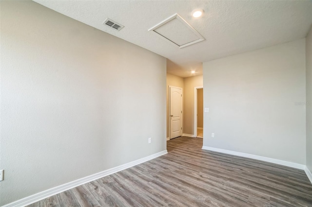 129 Eagleview Loop, Davenport, FL 33837 - unfurnished room featuring attic access and wood finished floors