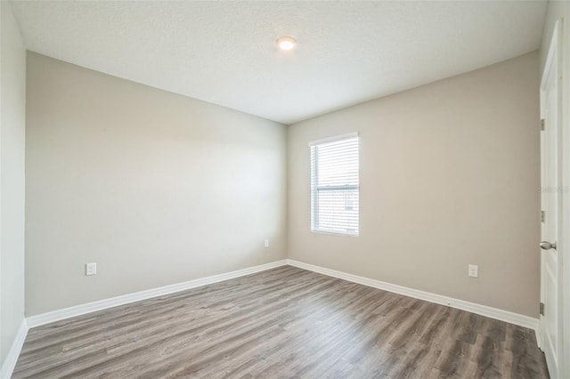 129 Eagleview Loop, Davenport, FL 33837 - empty room with wood finished floors and baseboards