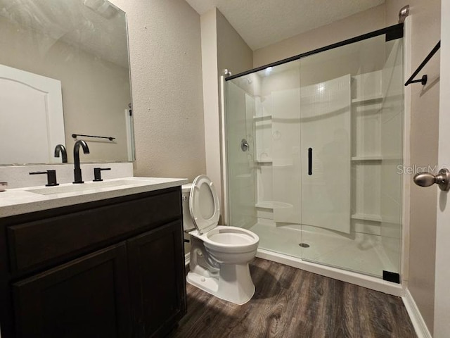 129 Eagleview Loop, Davenport, FL 33837 - full bath with wood finished floors, a shower stall, vanity, and a textured wall