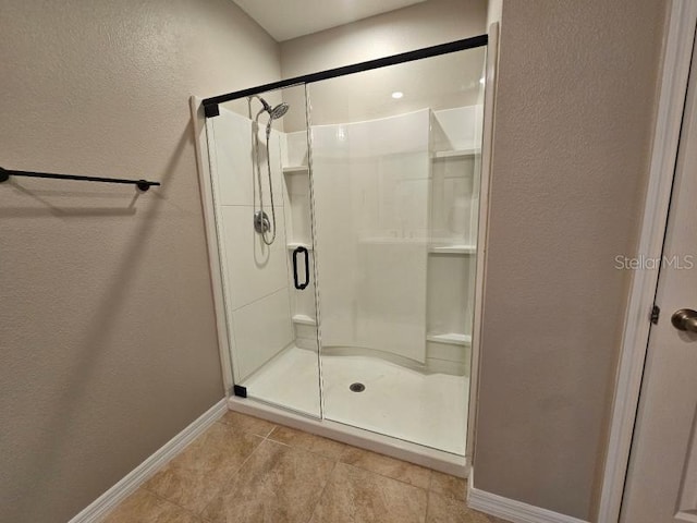 129 Eagleview Loop, Davenport, FL 33837 - full bathroom featuring a textured wall, a stall shower, and tile patterned flooring