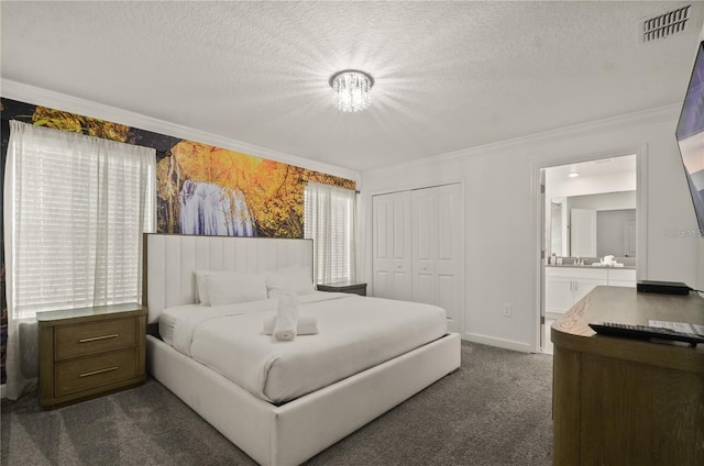 4363 Scene Ln, Kissimmee, FL 34746 - bedroom with crown molding, dark colored carpet, a textured ceiling, a closet, and ensuite bathroom