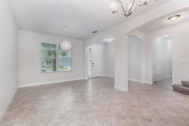 17044 Goldcrest Loop, Clermont, FL 34714 - entrance foyer with arched walkways, a chandelier, stairs, light tile patterned floors, and baseboards