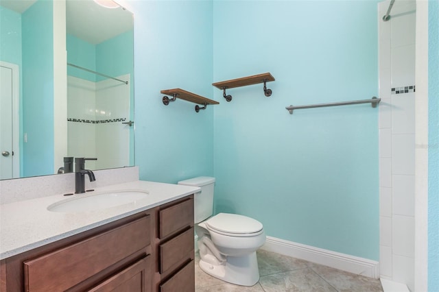 17044 Goldcrest Loop, Clermont, FL 34714 - bathroom with toilet, vanity, tile patterned floors, a tile shower, and baseboards