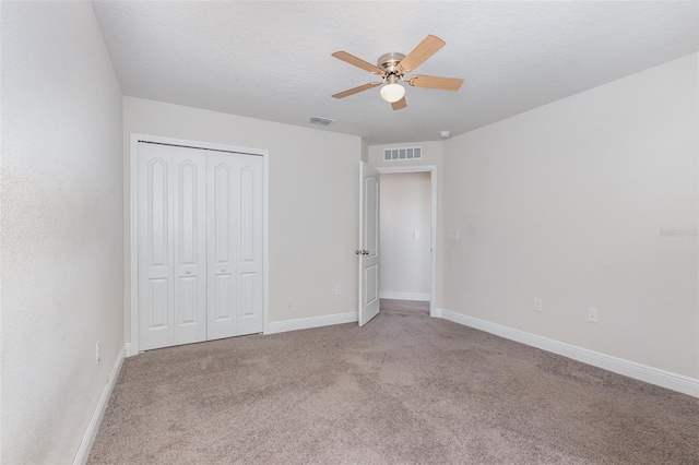 17044 Goldcrest Loop, Clermont, FL 34714 - unfurnished bedroom with carpet flooring, baseboards, a closet, a ceiling fan, and a textured ceiling